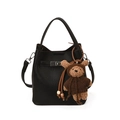Black litchi grain leather bucket bag with a brown teddy bear pendant and silver hardware - With Pendant / Black