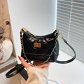Chic black quilted bucket bag with golden chain handle and vintage leather texture - Black