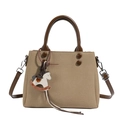 Khaki canvas crossbody bag with brown leather handles and a rocking horse charm - Khaki