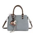 Gray canvas tote bag with brown leather handles and decorative rocking horse charm - Blue