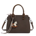 Dark brown cross-grain leather tote bag with long strap and horse charm accessory - Coffee
