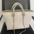 Detailed view of beige woven tote bag with tan leather trim and metal chain straps - M / Off White