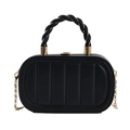 Vertical quilted black handbag with gold chain strap and stylish twist handle on white background - Black