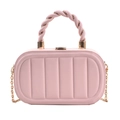 Close-up of pink box bag featuring vertical embossed patterns and woven top handle - Pink