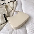 Minimalist cream-colored crescent underarm bag with adjustable strap and silver metal buckle - Off White