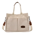 Off-white corduroy tote bag with large front pockets and a wide adjustable shoulder strap - Off White