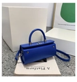 Elegant Klein blue leather cylinder bag with silver twist lock and crossbody strap - Blue