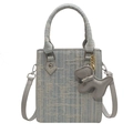 Light blue and beige woven crossbody handbag featuring a decorative grey puppy charm - With Pendant / Light Blue