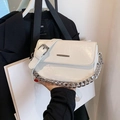 Modern white faux leather crossbody bag with silver chain detail and glossy finish - White
