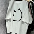 Vue détaillée du grand imprimé smiley noir sur le t-shirt blanc en coton ample - Blanc