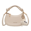 Cream hobo bag with knotted handle and plush monster charm on a white background - Off White