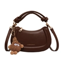 Dark brown leather crescent handbag with gold logo and plush charm accessory - Brown
