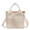 Beige canvas tote bag with front pocket and adjustable shoulder strap for women - Off-white