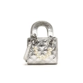 Silver quilted bucket bag with pearl handle and metallic finish, styled in cross-body design - Silver