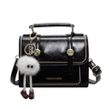Glossy black underarm bag with gold studs and a white fuzzy monster charm accessory - Black