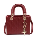 Classic dark red quilted leather handbag with gold star pendant and top handles - Red