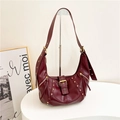 Vintage burgundy leather hobo bag with gold studs and rivets on a display stand - Red