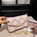 Pink crossbody bag with white clover patterns and gold chain shoulder strap - Pink