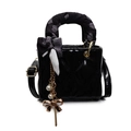 Mini black quilted bag in glossy finish with decorative silk scarf and gold bow charm - Black