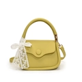 Elegant lime green pebbled leather crossbody tote bag with a white lace bow charm - Yellow