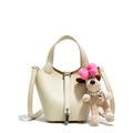 Creamy white lychee grain leather bucket bag with silver padlock and plush dog charm - White