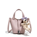 Pink lychee grain leather bucket bag with silver lock and plush dog charm pendant - Pink