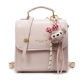 Rosa Mini-Lederrucksack mit goldenen Beschlägen und Plüschanhänger für Damen - Mit Anhänger / Rosa