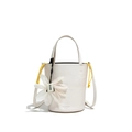 White minimalist bucket bag with yellow drawstrings and white floral charm - White