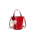 Chic red leather bucket bag with top handles and a delicate white floral charm - Red
