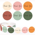 Macro detail of six pastel color Thank You seal stickers for gift boxes and packaging labels - Low Saturation Morandi (GG24)