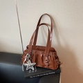 Brown glossy leather shoulder bag with star charm on top of a design book - With Pendant / Brown