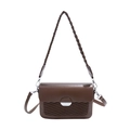 Brown faux leather crossbody bag with woven texture and braided handle on white background - Brown