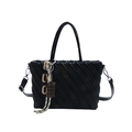 Black woven textured handbag with shoulder strap and chocolate pendant on white background - Black