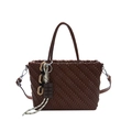 Dark brown tote bag with woven texture, featuring a chocolate charm and crossbody strap - Brown
