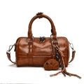 Dark brown glossy leather Boston bag with a cute bear pendant and silver hardware details - Brown with Pendant