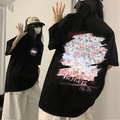 Oversized black cotton T-shirt featuring artistic floral mountain print and urban text - Black