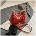 Detail of red quilted faux leather bag with gold chain strap and metallic twist lock - Burgundy