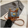 Detail of light blue denim hobo bag with diamond quilting and gold twist lock closure - Denim Blue