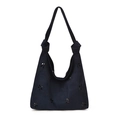 Dark blue suede tote bag with laser-cut flower patterns and knotted shoulder strap detail - Blue
