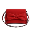 Red crossbody bag with large bow and silver metal chain strap on white background - Red