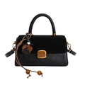 Minimalist black leather crossbody bag with suede flap and gold buckle on white background - With Pendant / Black
