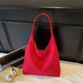 Large capacity red suede hobo shoulder bag styled in a modern minimalist office setting - Red