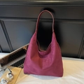 Close-up of a large burgundy suede tote bag styled in a modern office desk setting - Burgundy