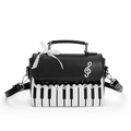 Chic piano theme handbag featuring black and white polka dots and lace details - Black