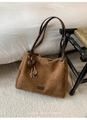 Close-up of brown suede tote bag with leather heart charm and woven fringe detail - With Pendant / Brown