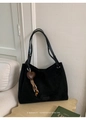 Close-up of black matte tote bag with brown heart charm and minimalist retro brand detail - With Pendant / Black