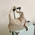 Quilted beige shoulder bag with a round coin purse on a striped suitcase - Khaki
