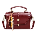 Deep red synthetic leather crossbody bag with wooden bead charm and gold buckle - With Pendant / Red