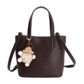 Dark brown pebble leather crossbody handbag with cute plush doll charm and top handle - Brown