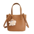 Caramel brown leather crossbody bucket bag with fuzzy charm and twin top handles - Cappuccino
